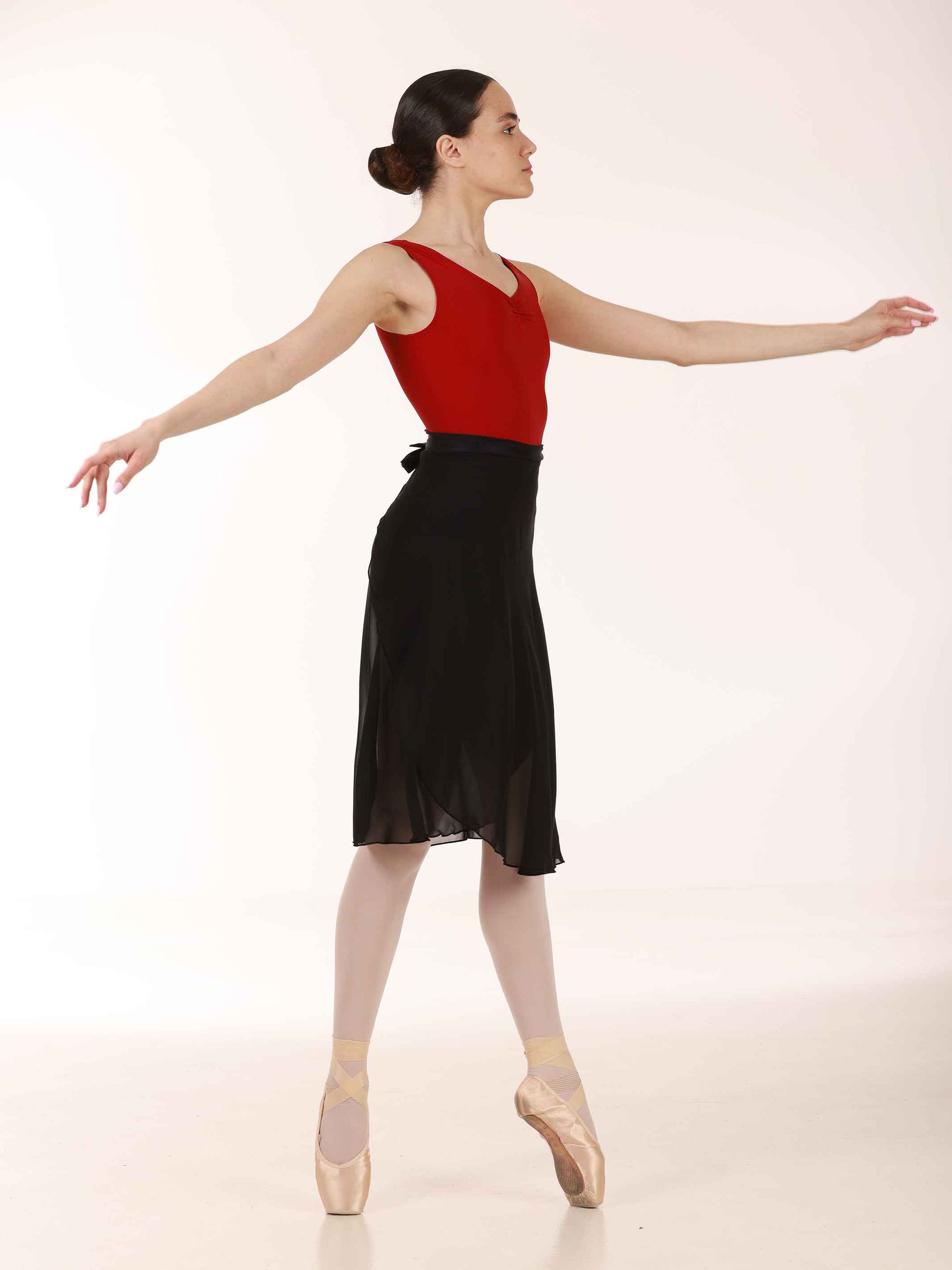 Ballerina wearing a long black chiffon skirt and red top