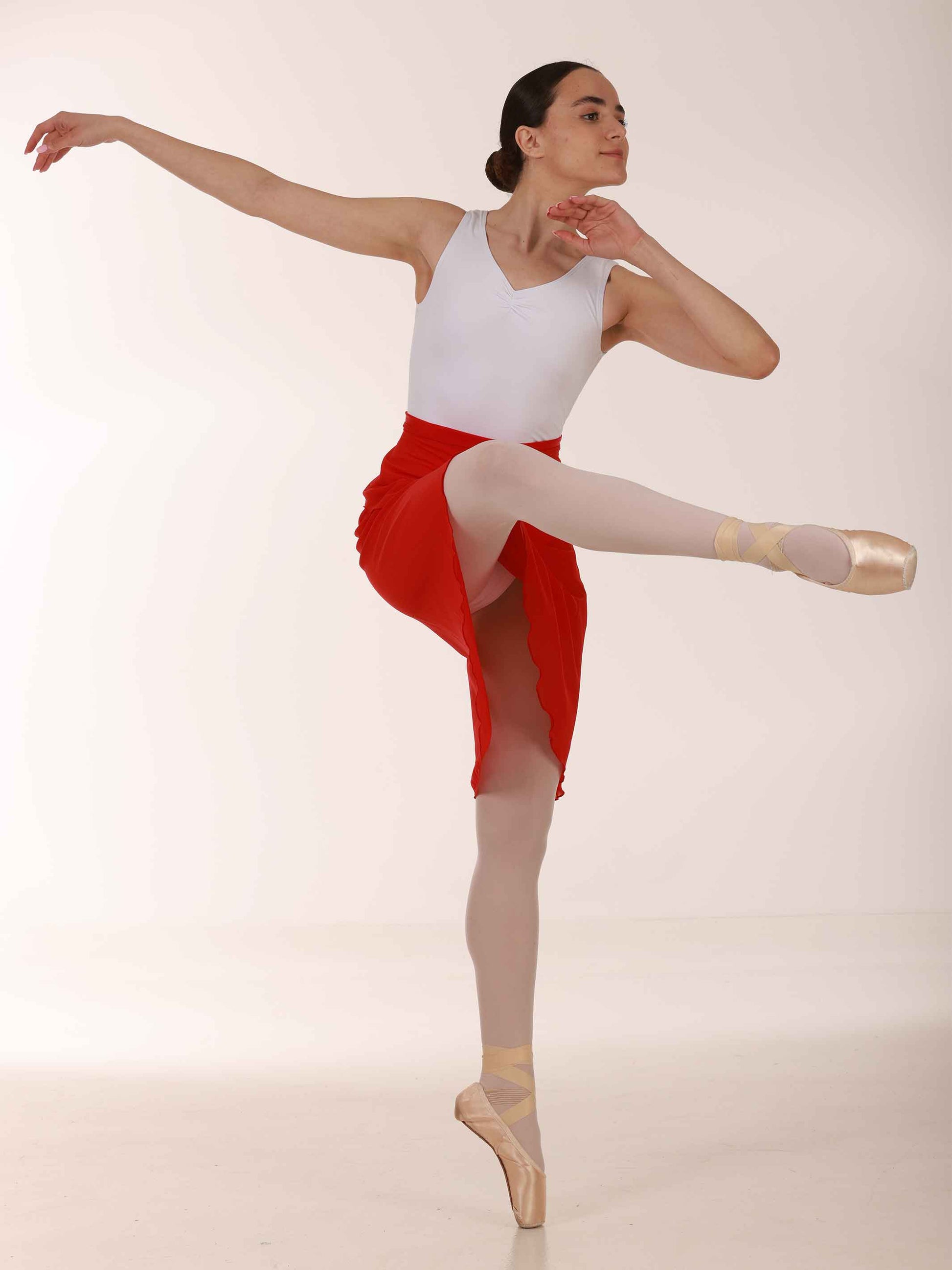 Ballerina wearing a long red chiffon skirt and white top