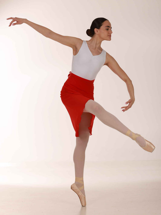 Ballerina wearing a long red chiffon skirt and white top