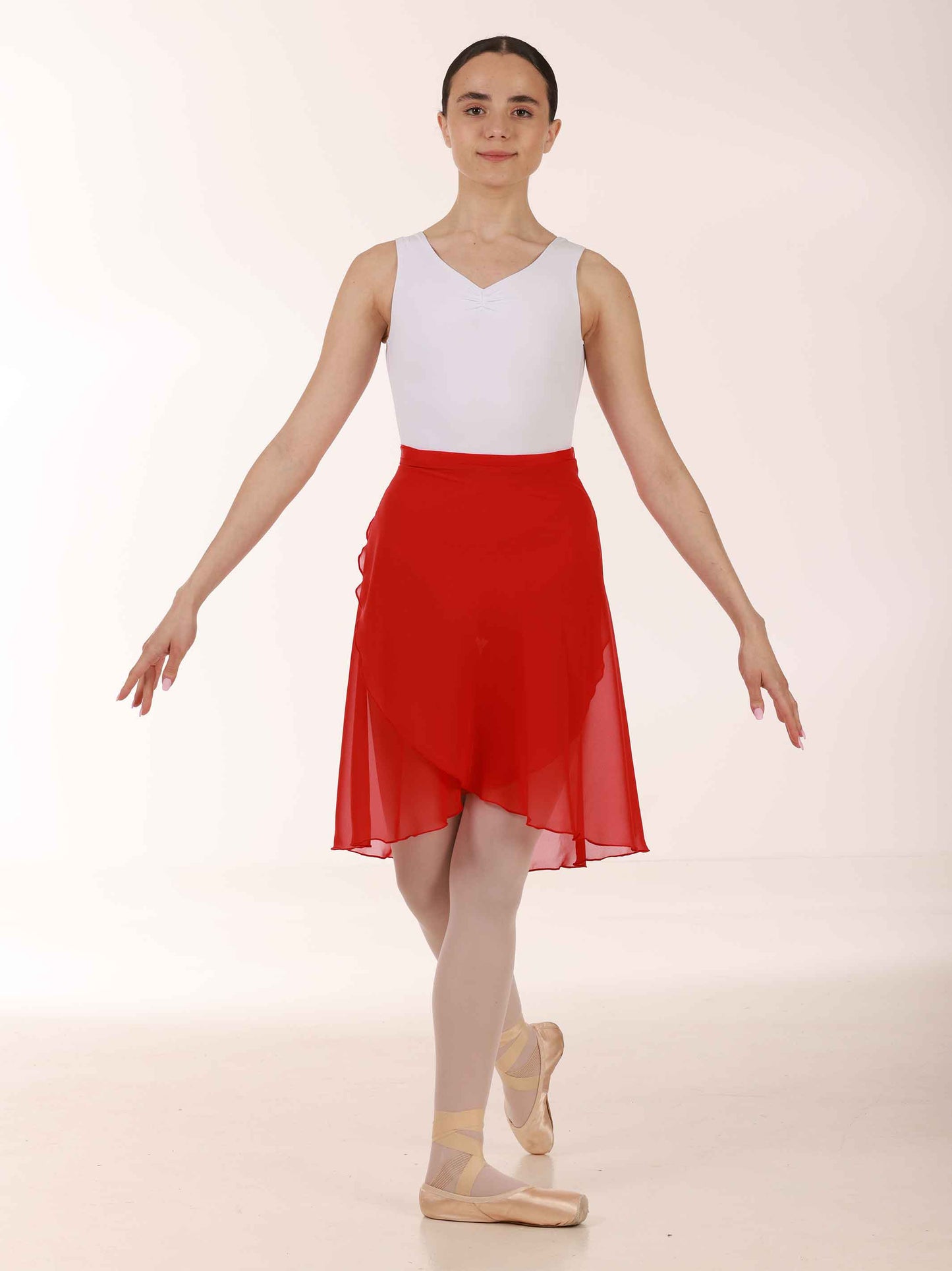 Ballerina wearing a long red chiffon skirt and white top