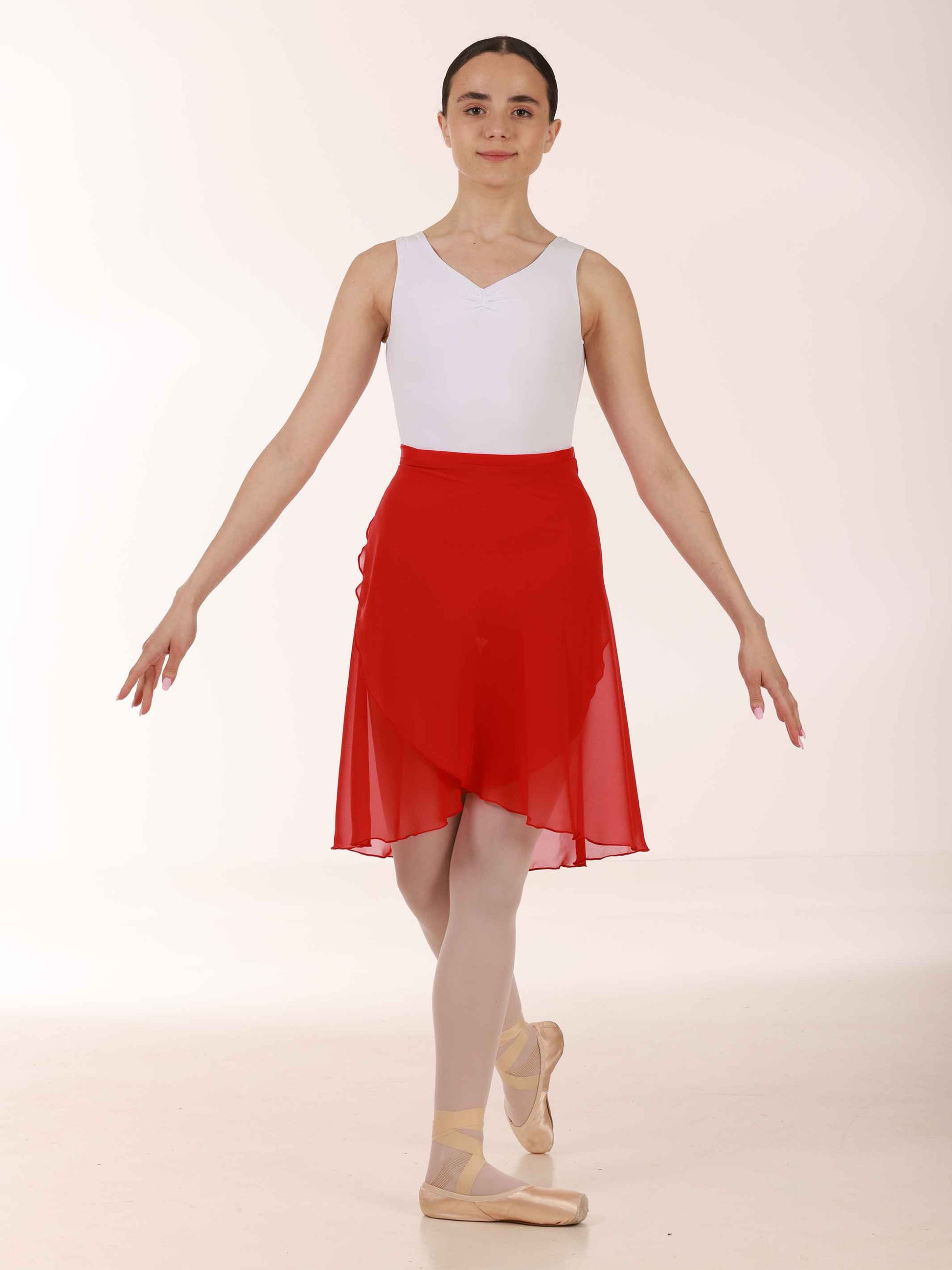Ballerina wearing a long red chiffon skirt and white top