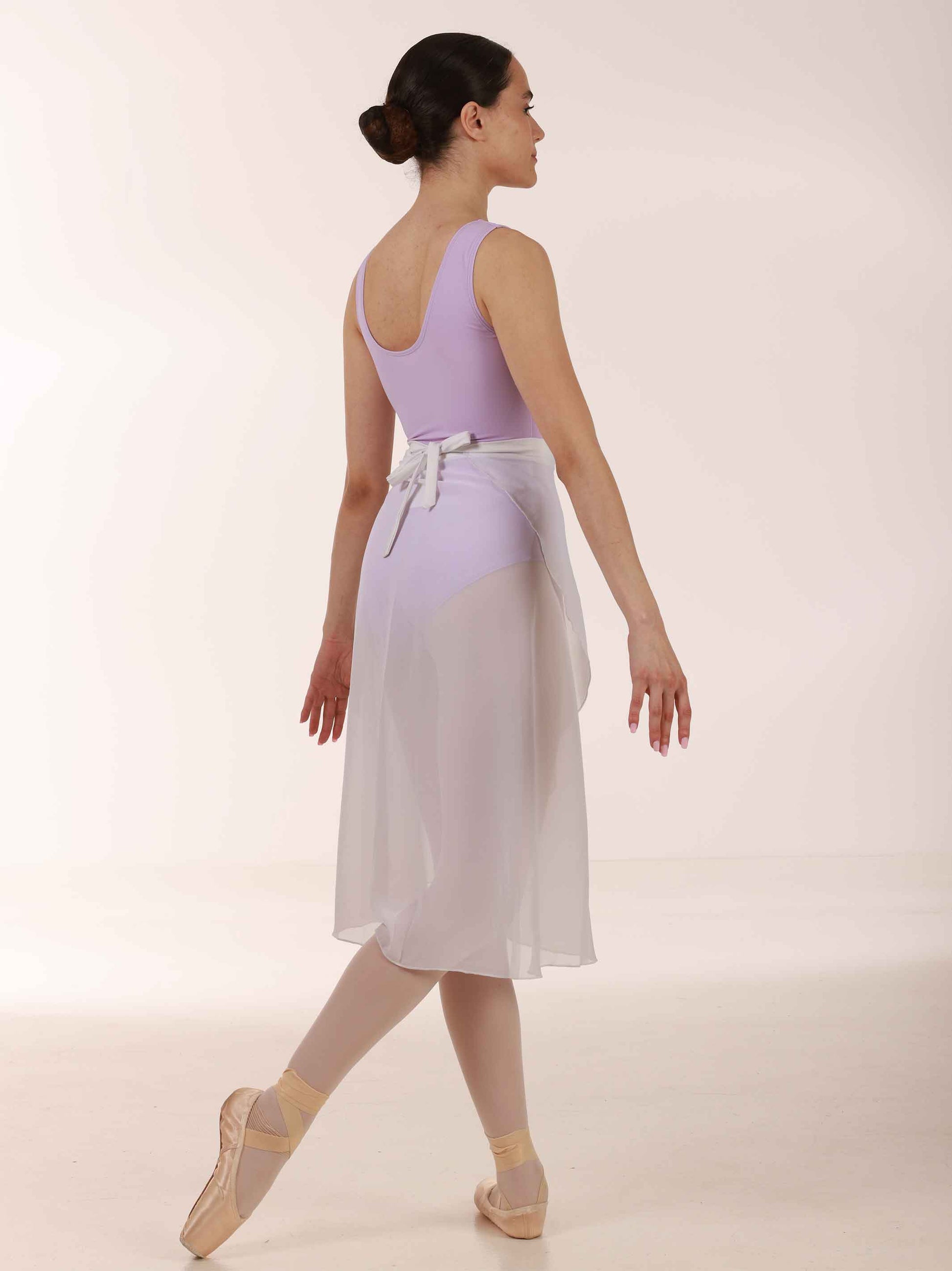 Ballerina wearing a long white chiffon skirt and lavender top