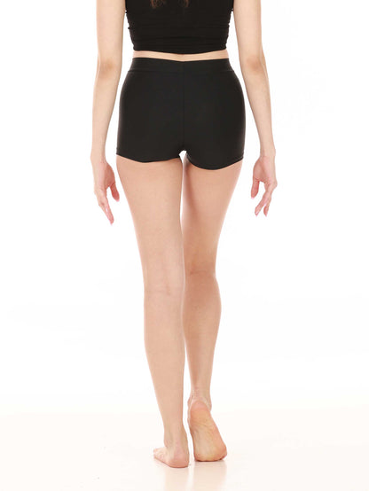 Person wearing black short-waisted shorts on a white background
