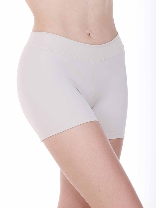White dance shorts worn by a person on a white background