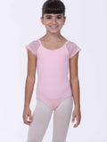 Young girl wearing a pink ballet leotard with sheer sleeves on a white background