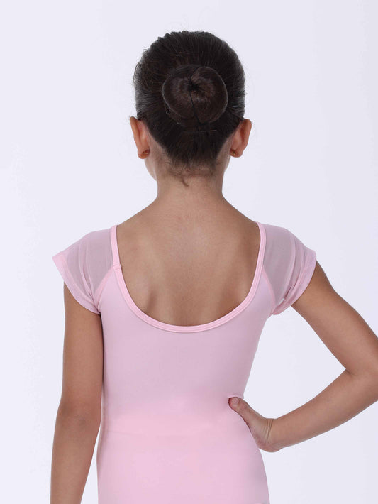 Young girl wearing a pink ballet leotard on a white background