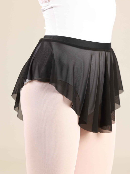 ballerina wearing an oval black ballet skirt with a white leotard