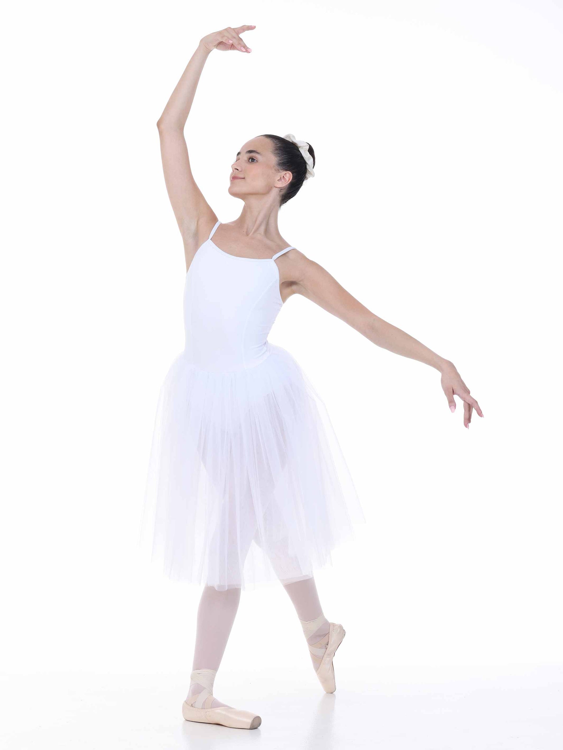 Ballerina in a white tutu dress posing on a white background