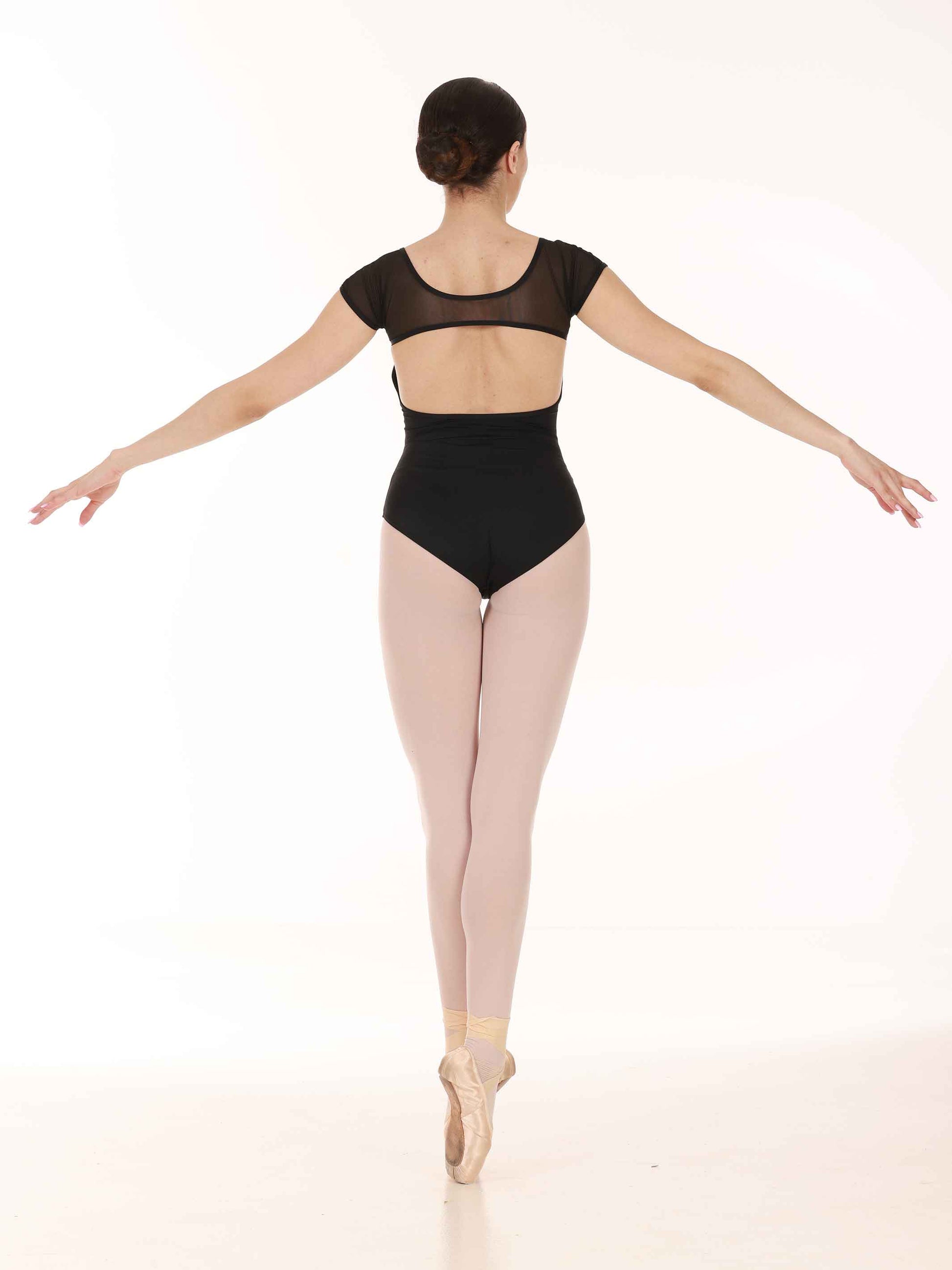 Ballerina in a black leotard and tights on a white background