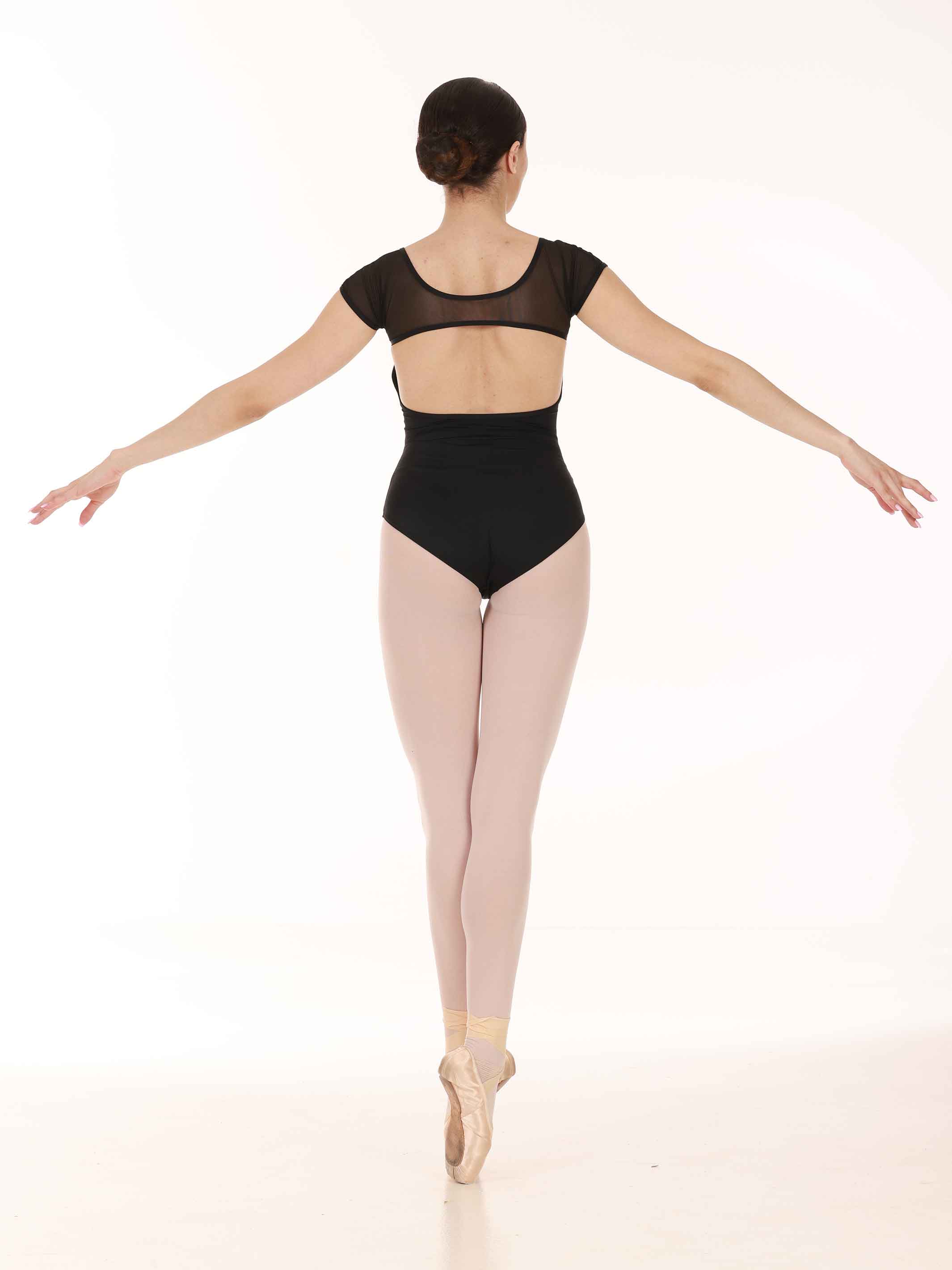 Ballerina in a black leotard and tights on a white background