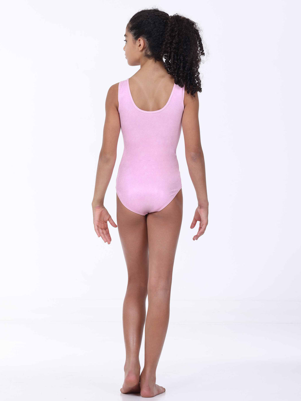 Person wearing a pink gymnastics leotard on a white background