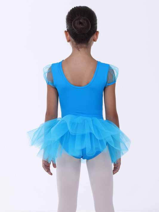 Child wearing a blue ballet dress with a tutu on a white background