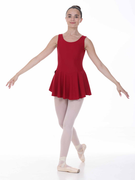 Ballerina in a burgundy dress and white tights posing on a white background