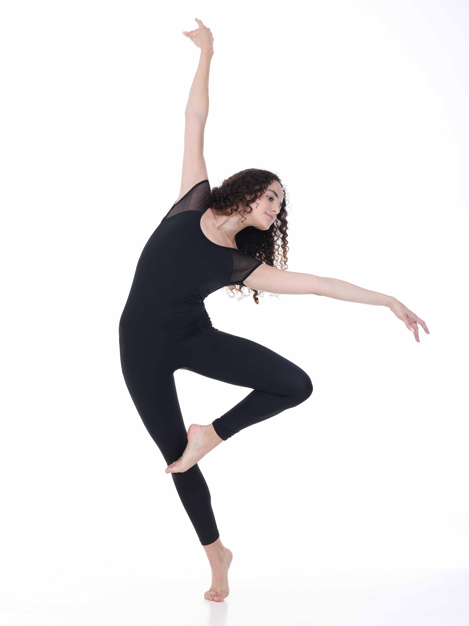 Dancer in a black outfit posing on a white background