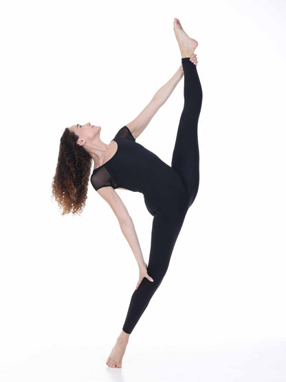 Woman in black athletic wear performing a yoga pose on a white background