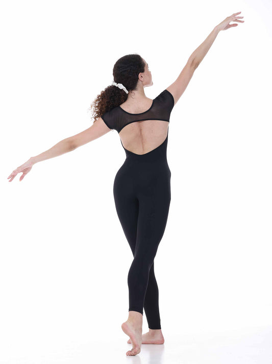 Dancer wearing a black open-back unitard on a white background