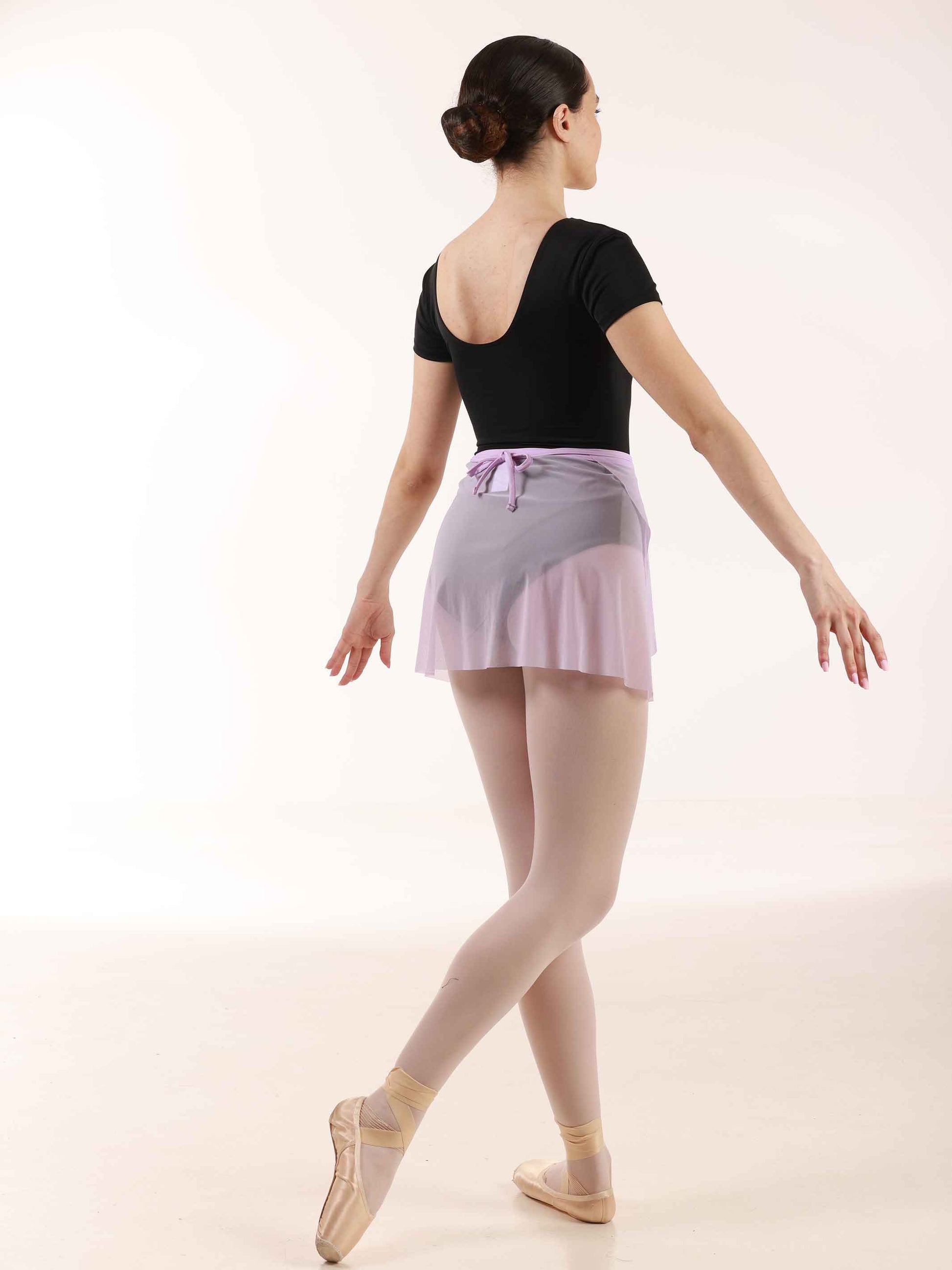 ballerina wearing a short lilac ballet wrap skirt and black leotard