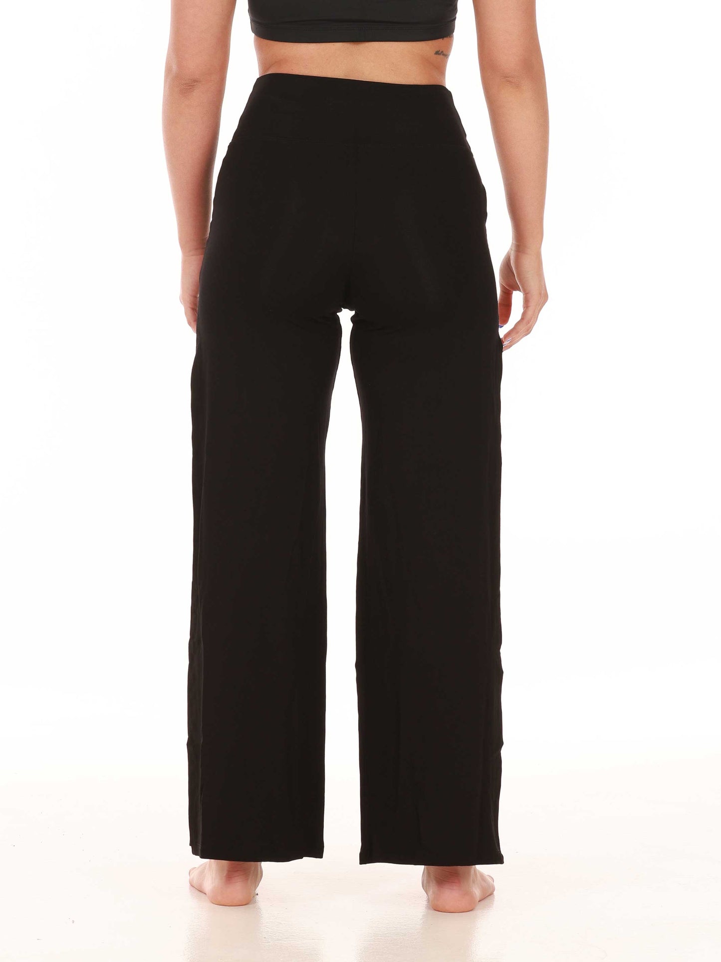 Black wide-leg jazz pants worn by a person on a white background