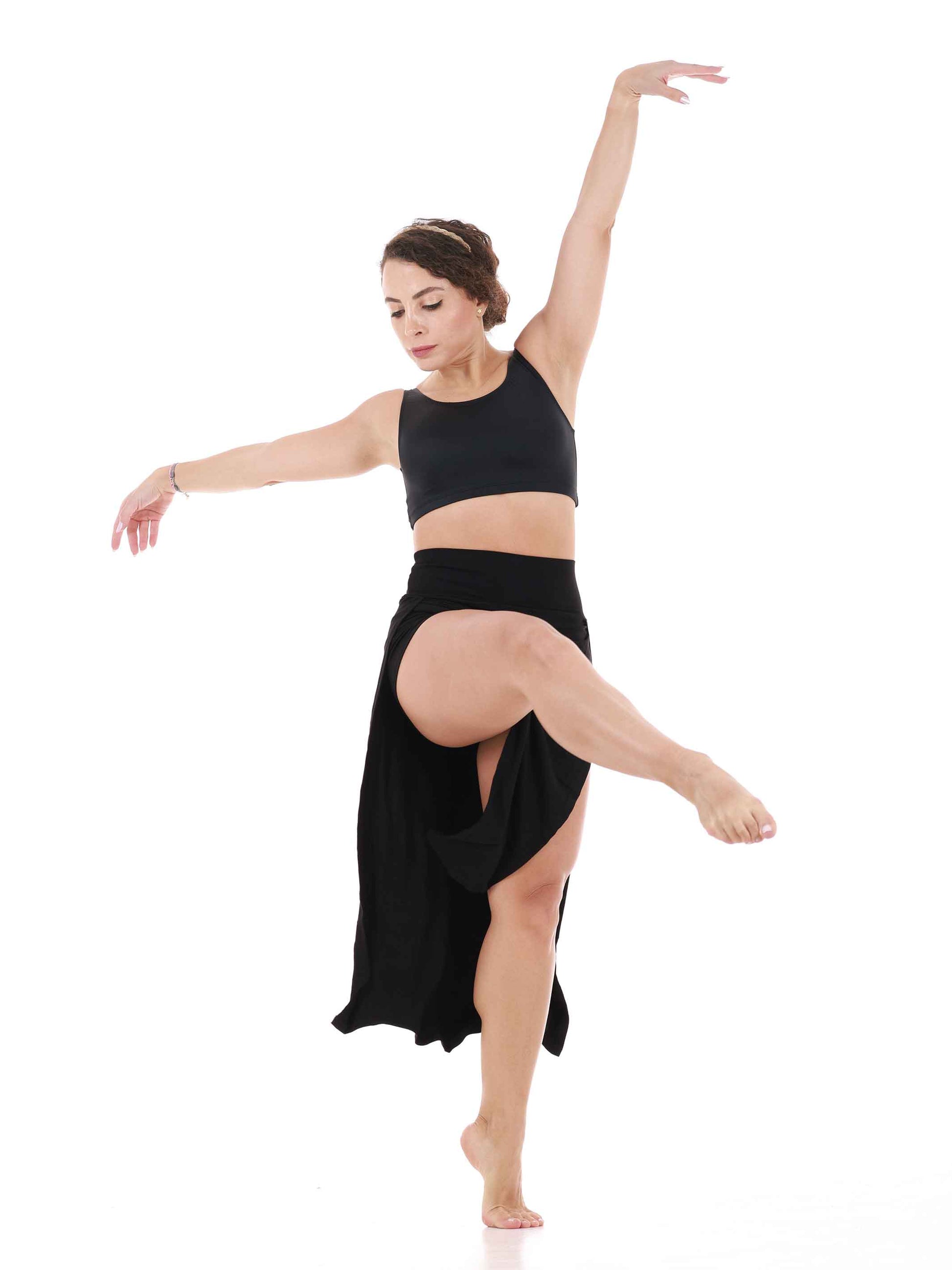 Dancer in a black outfit posing on a white background