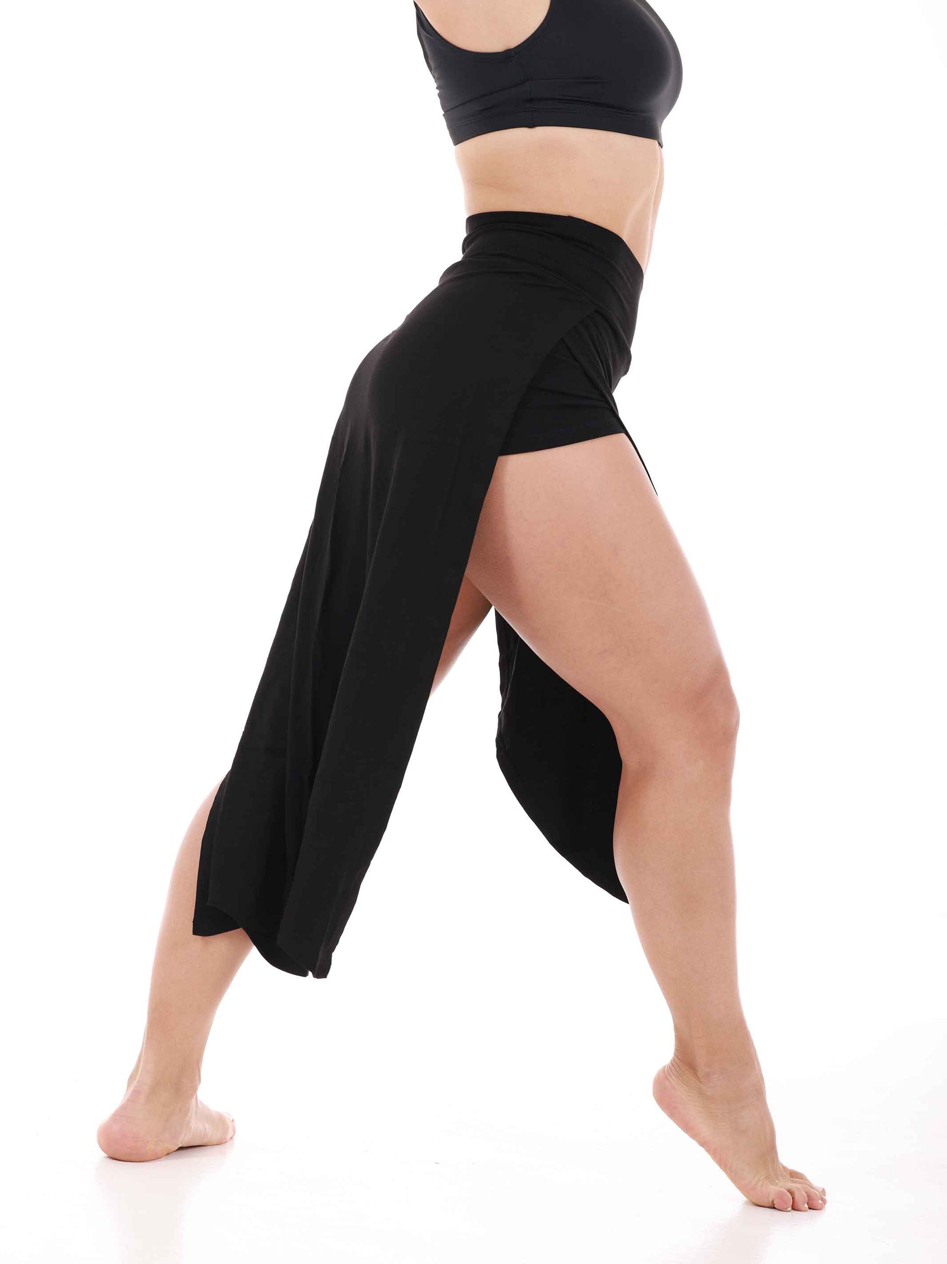 Person wearing a black dance skirt on a white background