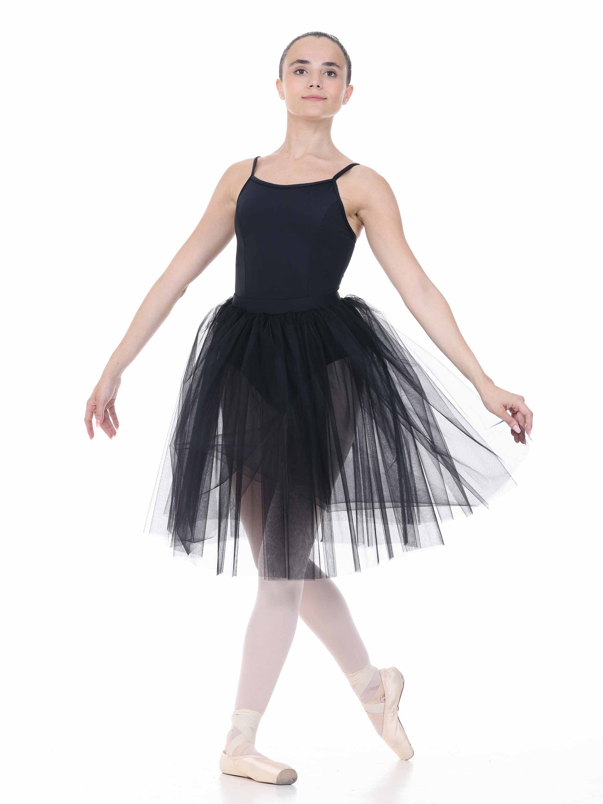 Ballerina in a black leotard and tutu on a white background