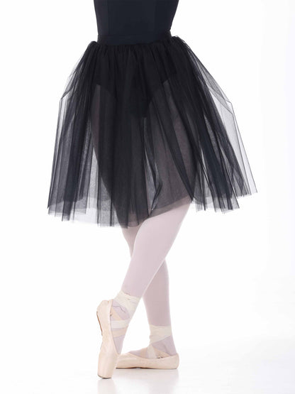 Ballerina wearing a black tutu and white tights on a white background