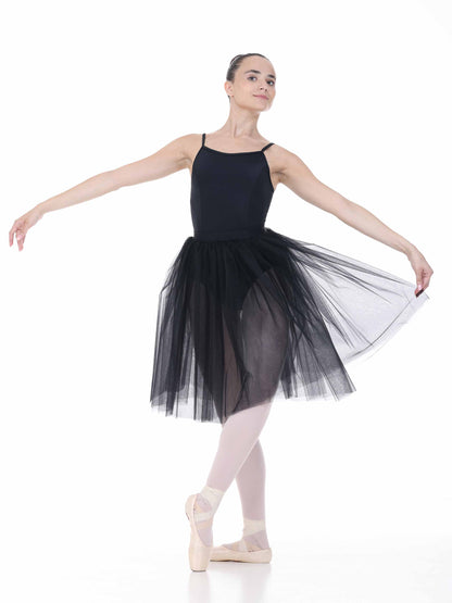 Ballerina in a black tutu posing on a white background
