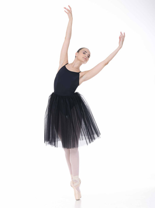 Ballerina in a black tutu posing on a white background