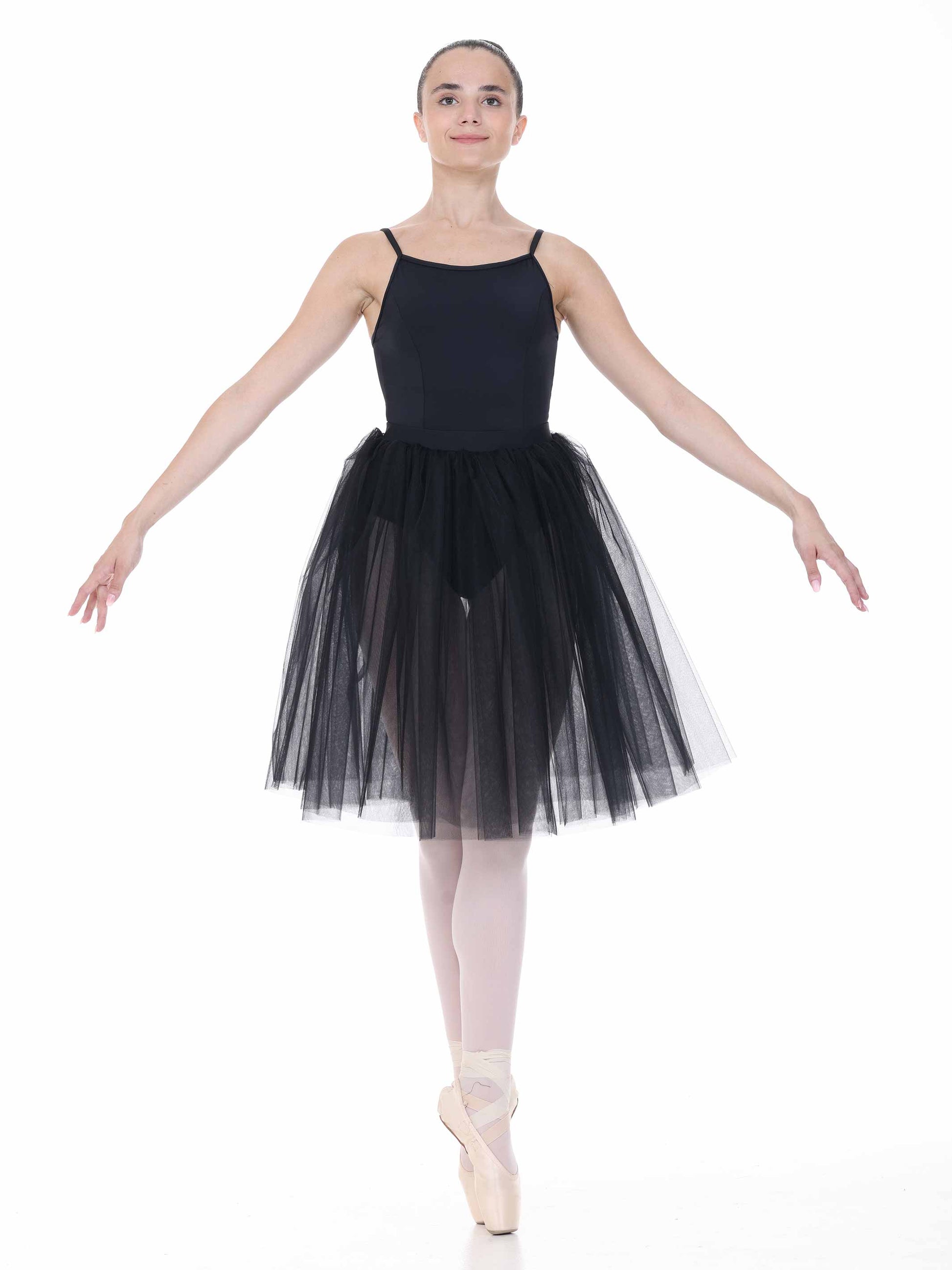 Ballerina in a black leotard and tutu on a white background