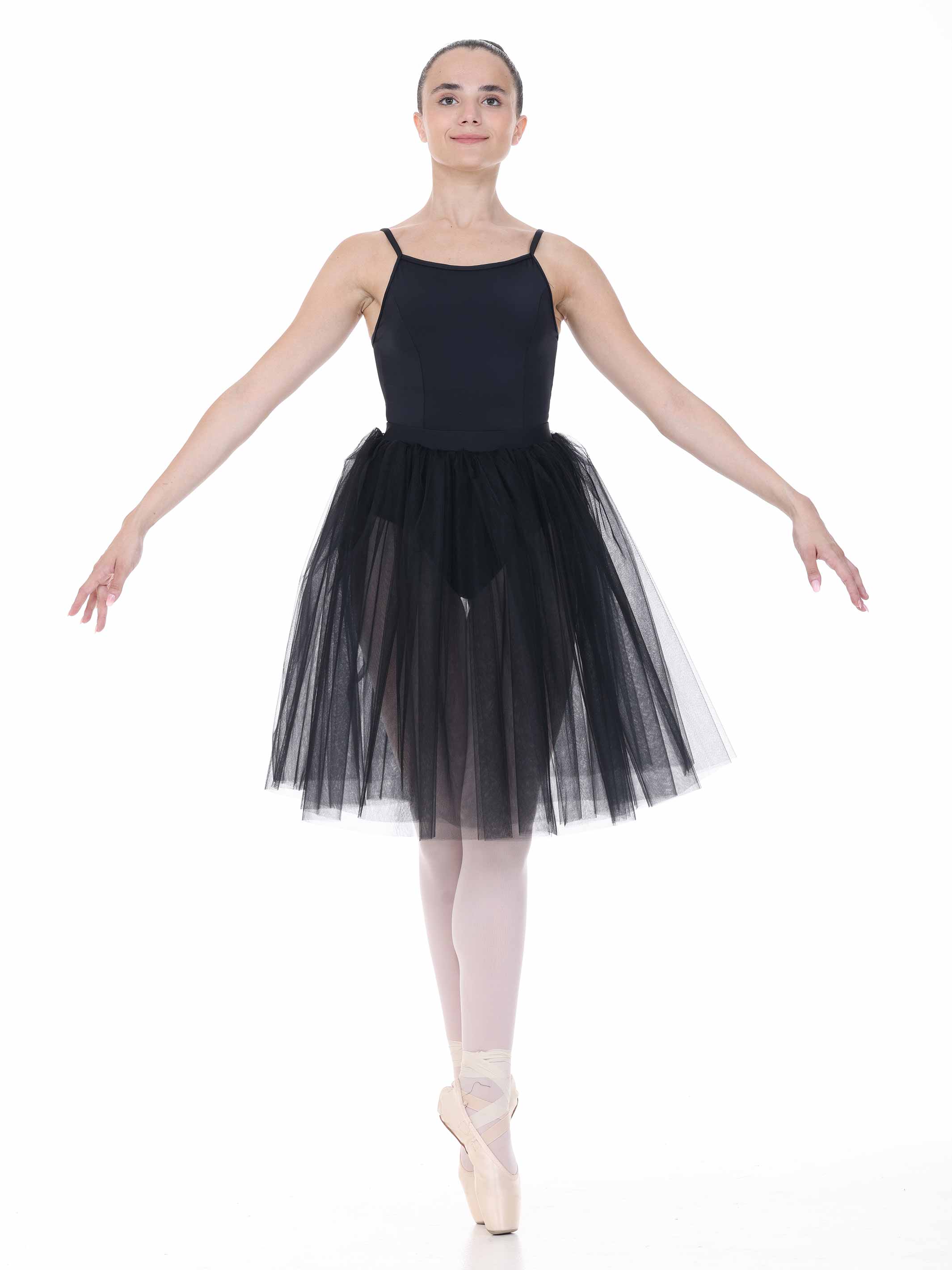 Ballerina in a black leotard and tutu on a white background