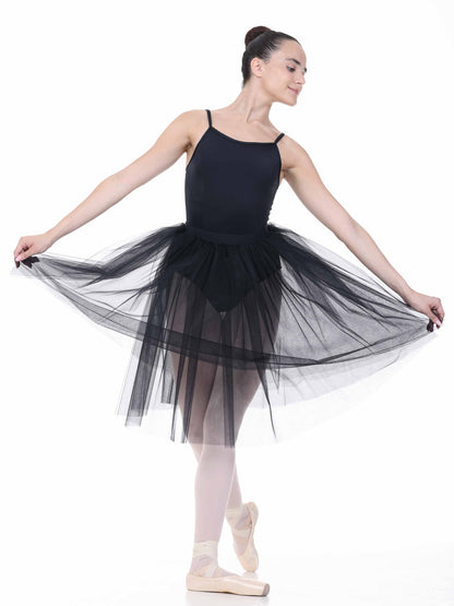 Ballerina in a black tutu posing on a white background