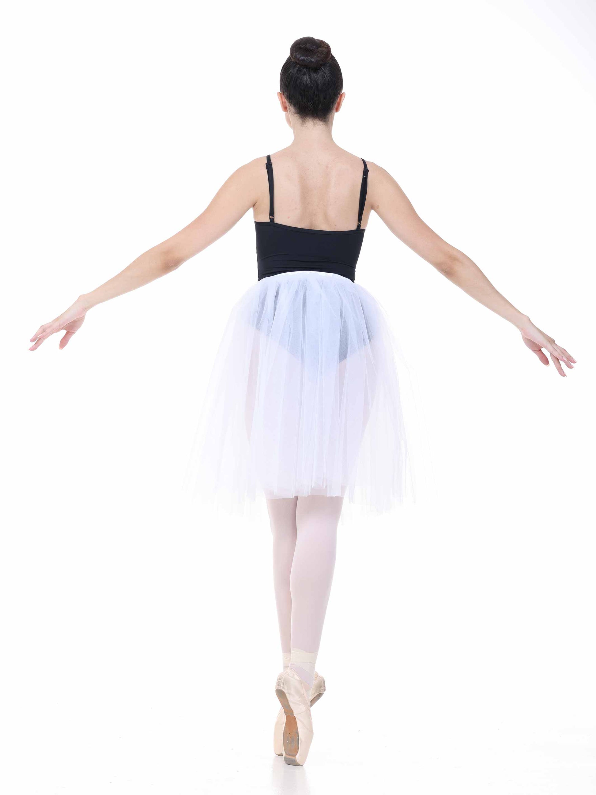 Ballerina in a black leotard and white tutu on a white background