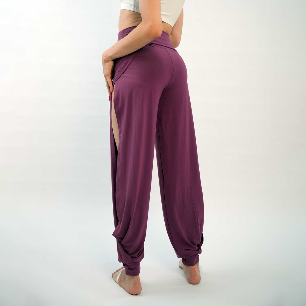 A pair of purple yoga dance jazz pants with a high-waisted fit and wide-leg design, featuring a secure waistband and a gathered ankle hem.