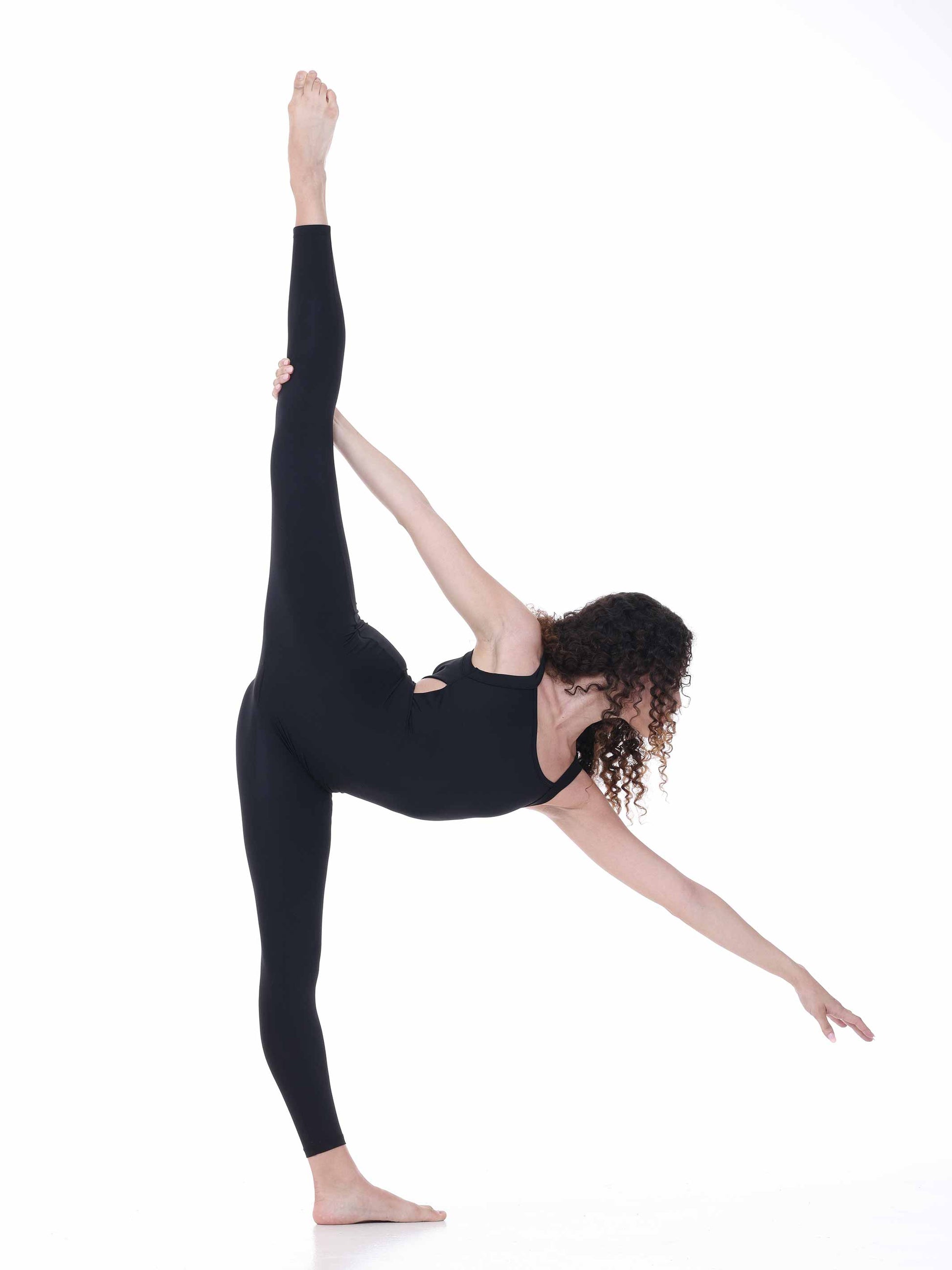 Person in a black outfit performing a yoga pose on a white background
