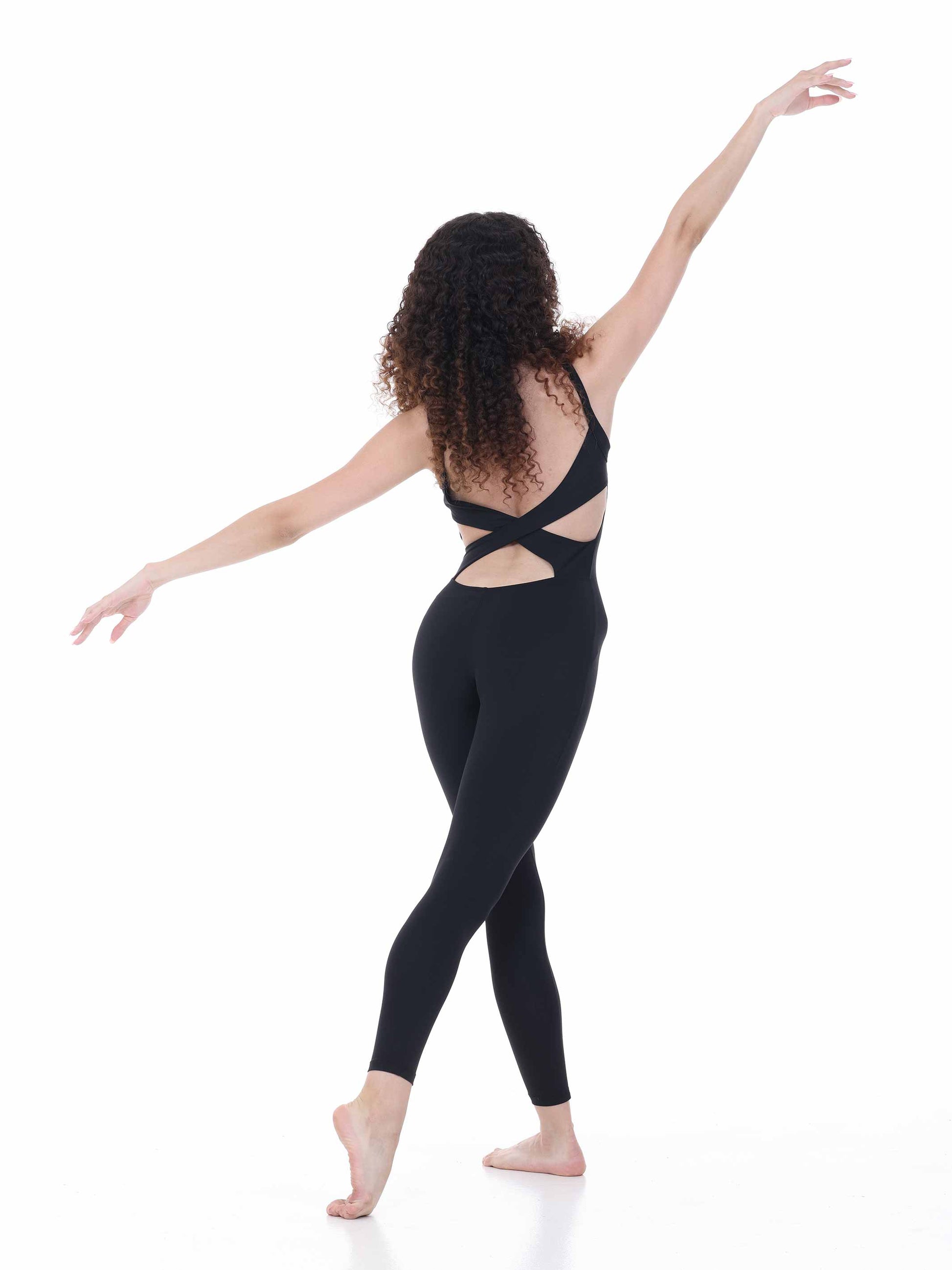 Woman wearing a black outfit with cut-out design on a white background