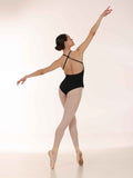 Ballerina in a black leotard and white tights posing on a white background