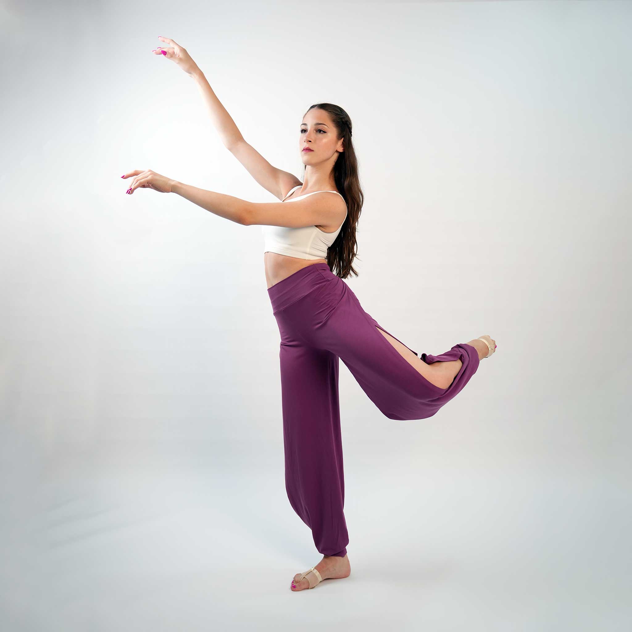 a dancer posing in a purple Jazz pants