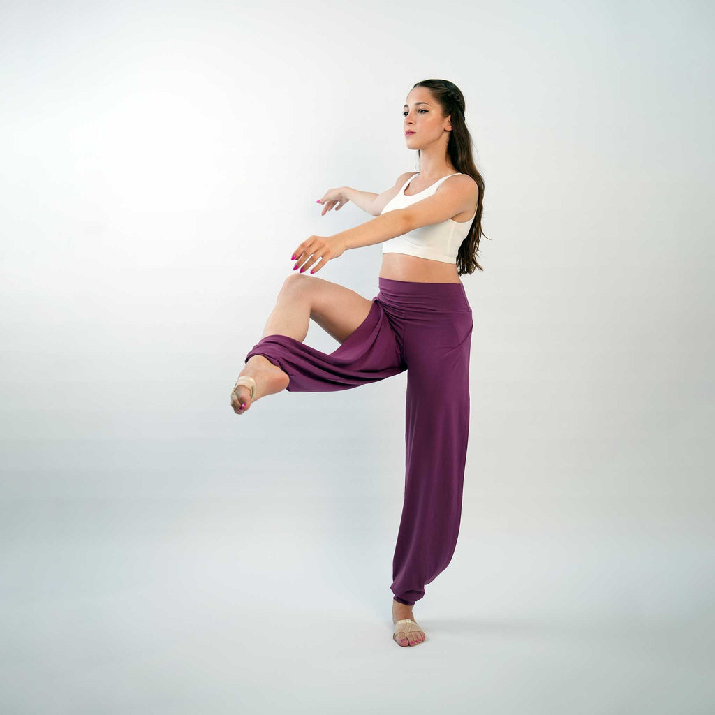 A pair of purple yoga dance jazz pants with a high-waisted fit and wide-leg design, featuring a secure waistband and a gathered ankle hem.