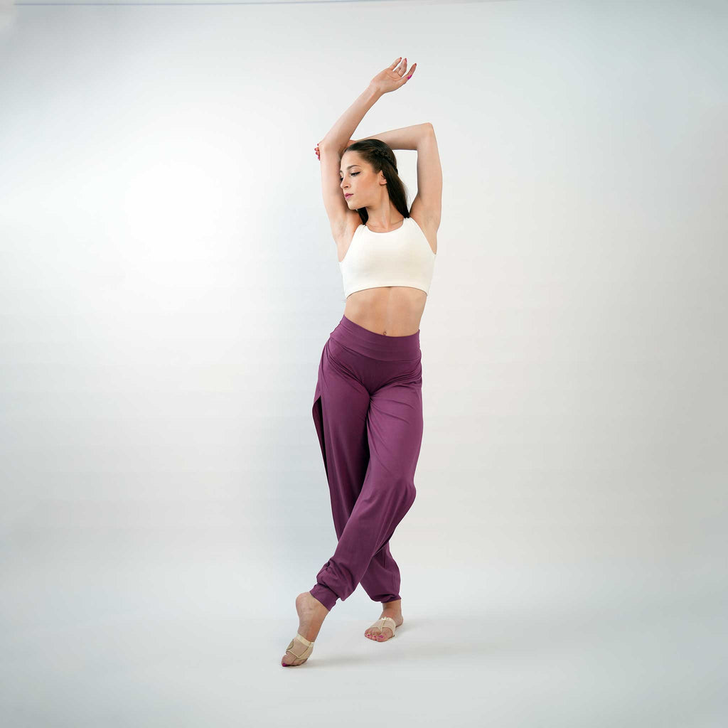 A pair of purple yoga dance jazz pants with a high-waisted fit and wide-leg design, featuring a secure waistband and a gathered ankle hem.