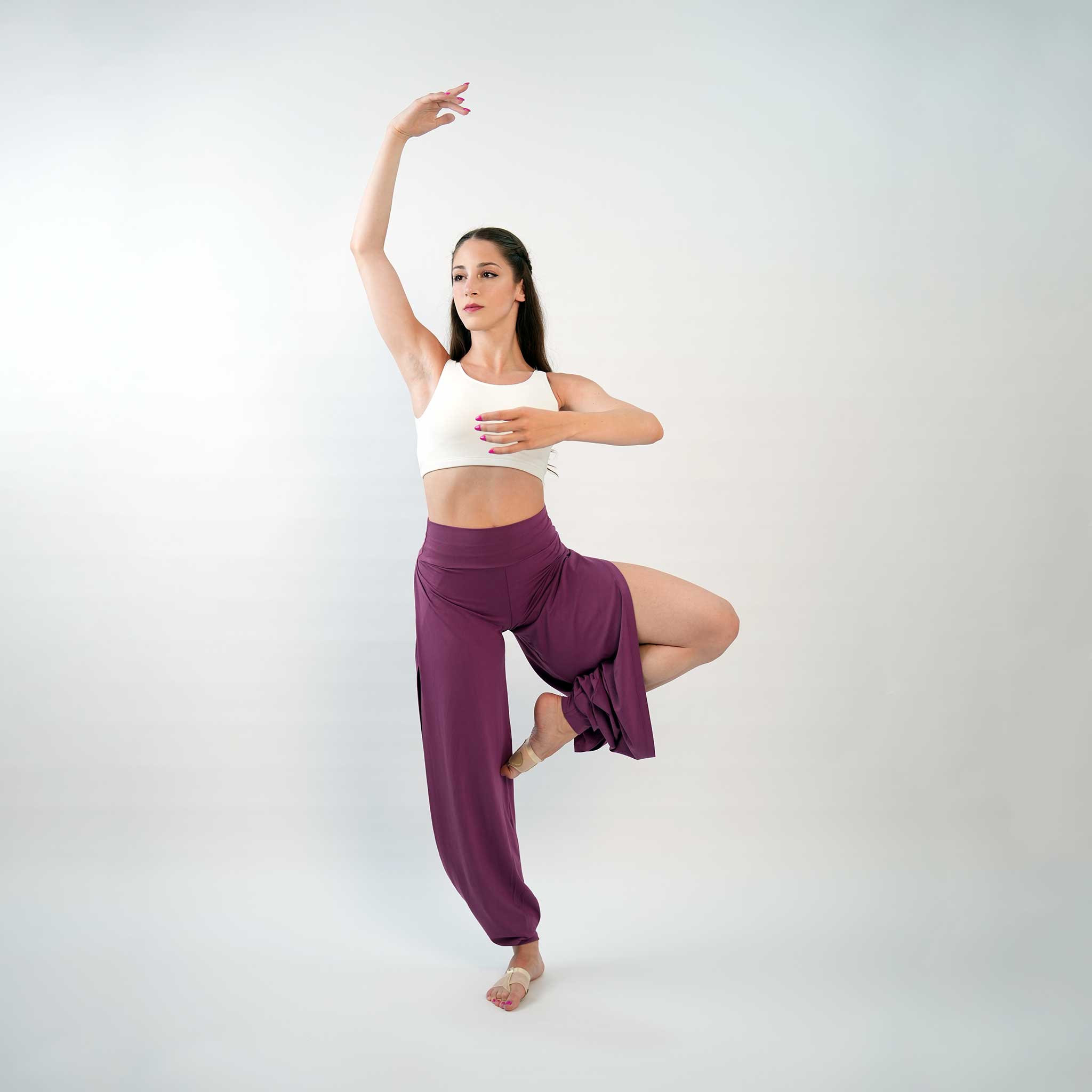 a dancer posing in a purple jazz pants