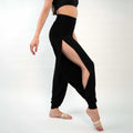 A pair of black yoga dance jazz pants with a high-waisted fit and wide-leg design, featuring a secure waistband and a gathered ankle hem.