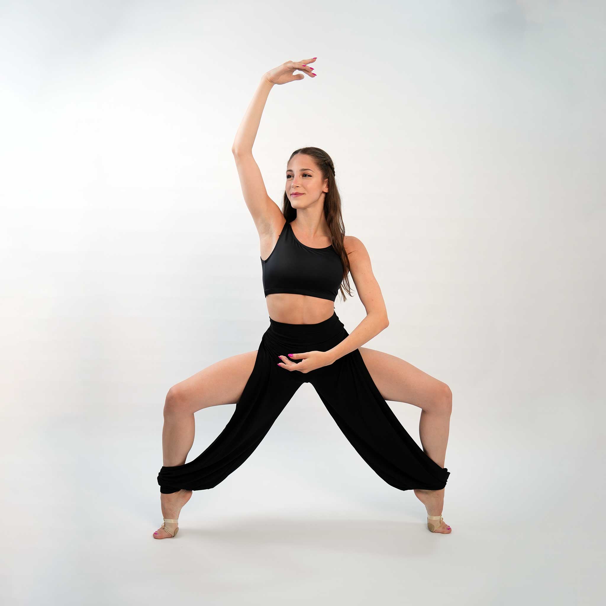 a dancer posing in a black jazz pants