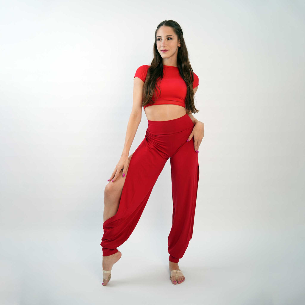 A pair of red yoga dance jazz pants with a high-waisted fit and wide-leg design, featuring a secure waistband and a gathered ankle hem.