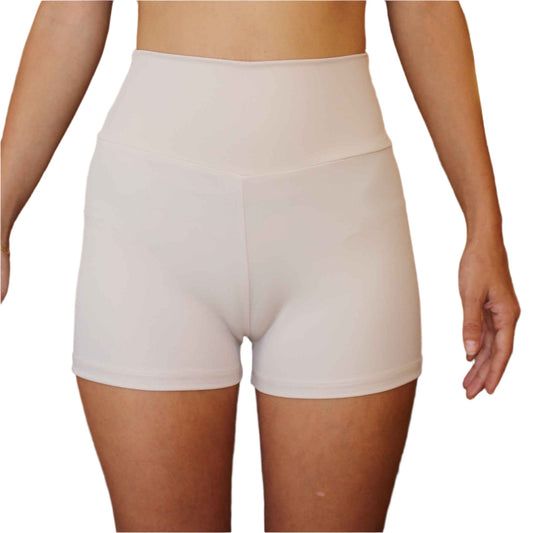 Beige high-waisted shorts worn by a person on a white background